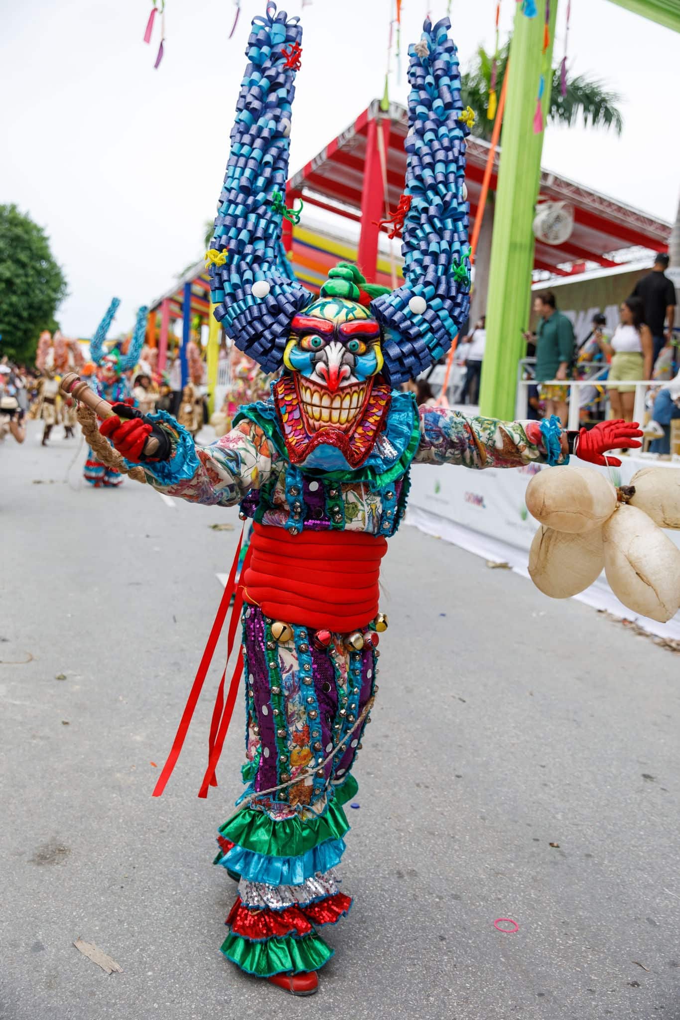 A man in a carnival costume and mask.