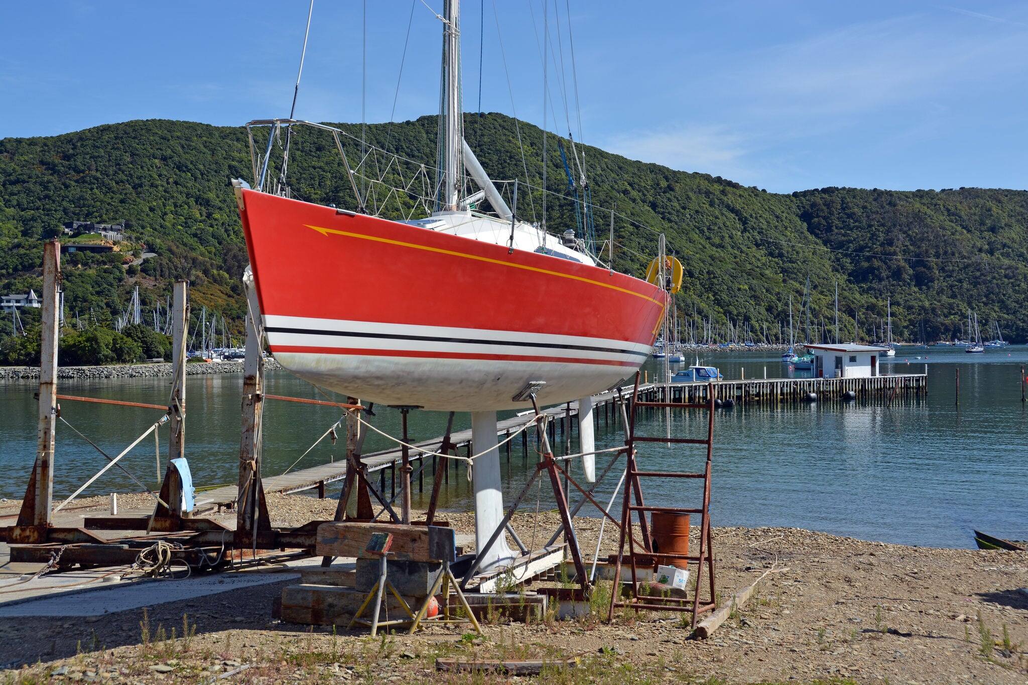 Red Yacht being repaired at a Shipyard in Waikawa Marina, Picton, New Zealand.