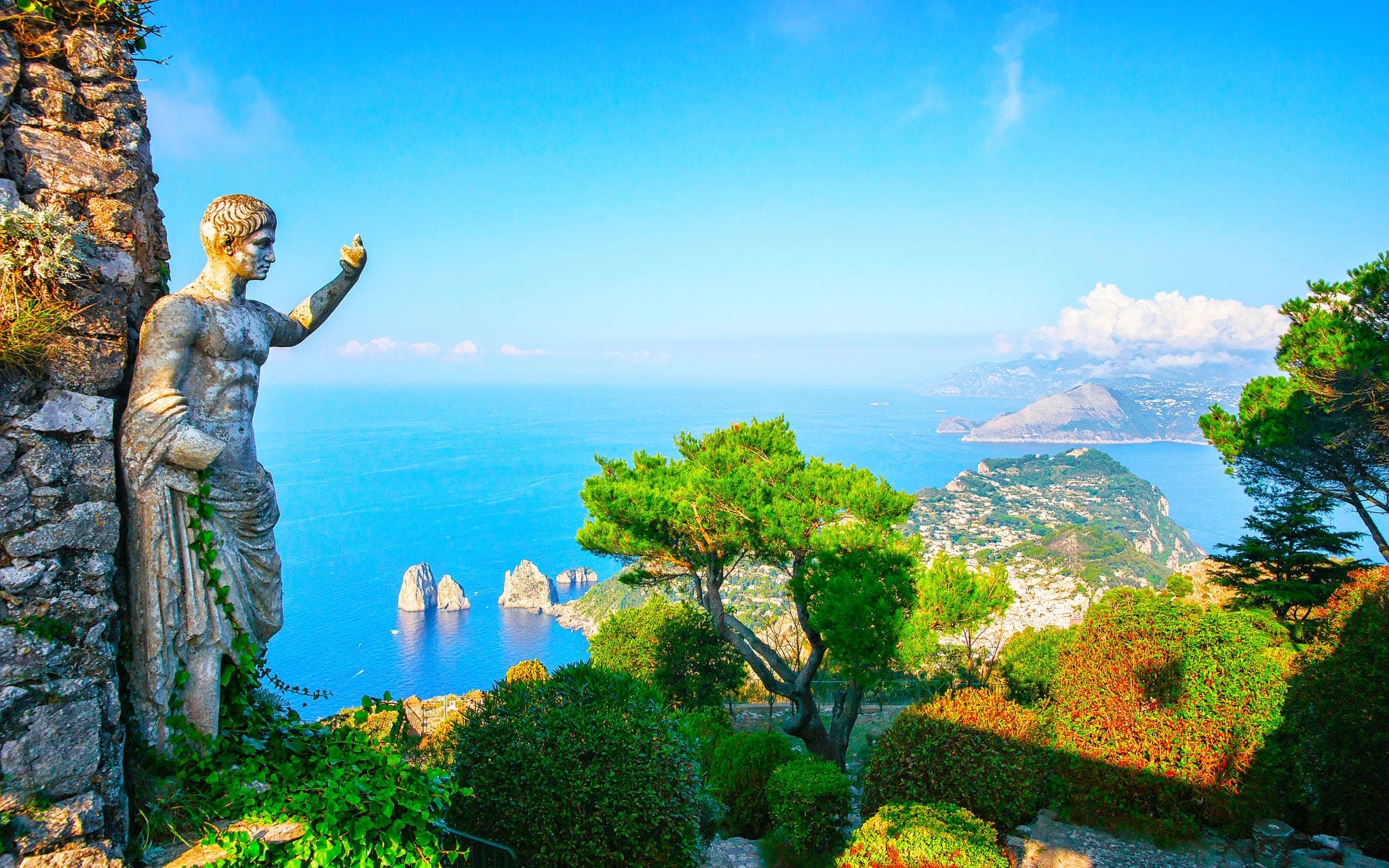 Statue at garden on Capri Island town, Italy. Amalfi scenery and Solaro mountain. Landscape with sculpture and Blue Mediterranean Sea, Italian coast. Anacapri in Europe. View on Faraglioni, summer.