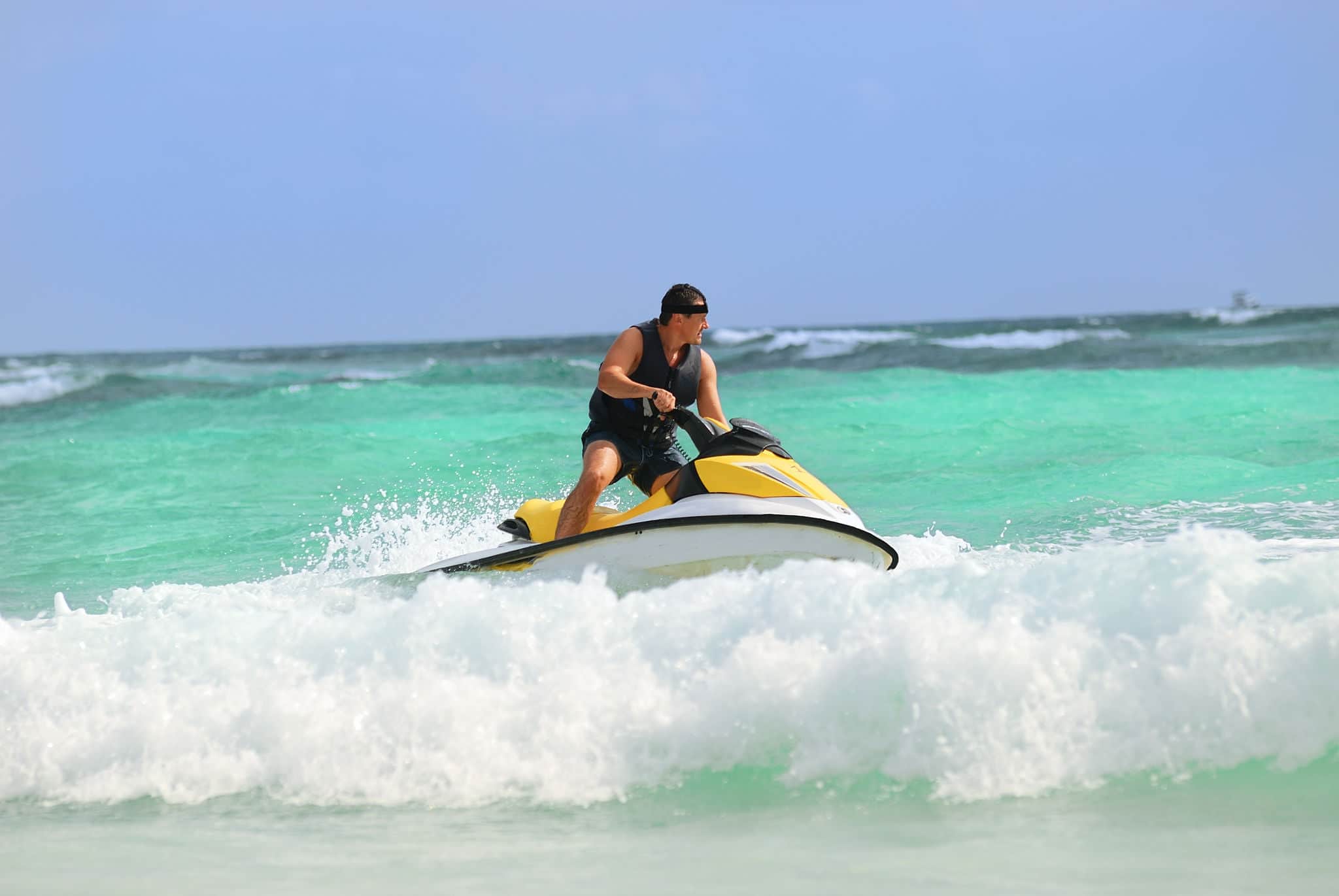 Man on Wave Runner turns fast on the water
