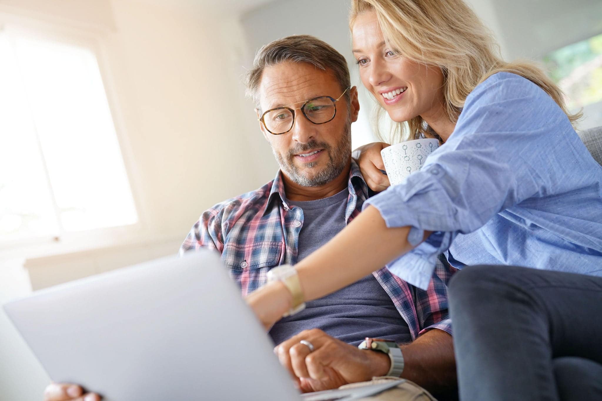 Mature couple connected on internet with laptop