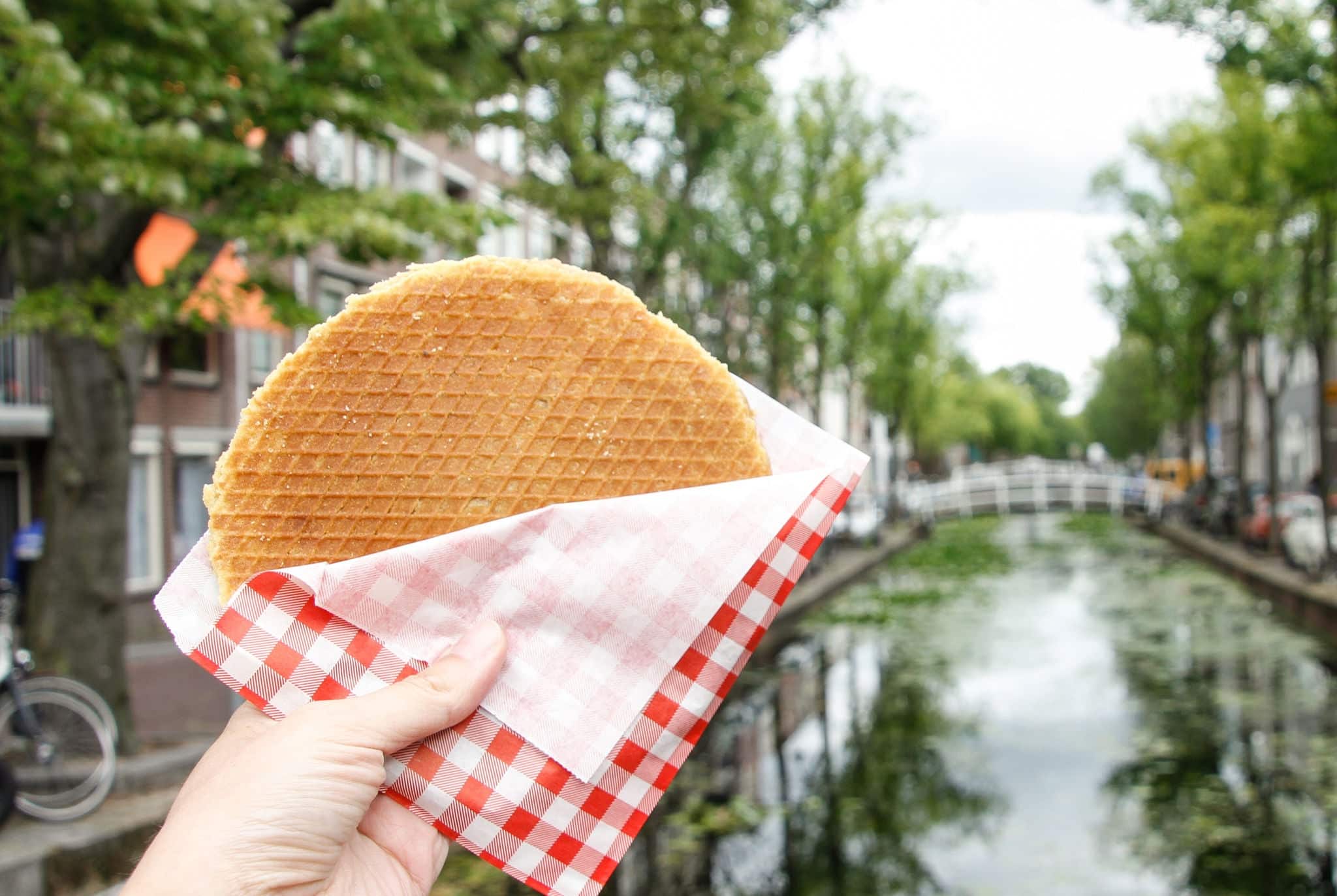 Typical Dutch stroopwafel with the canal in the background