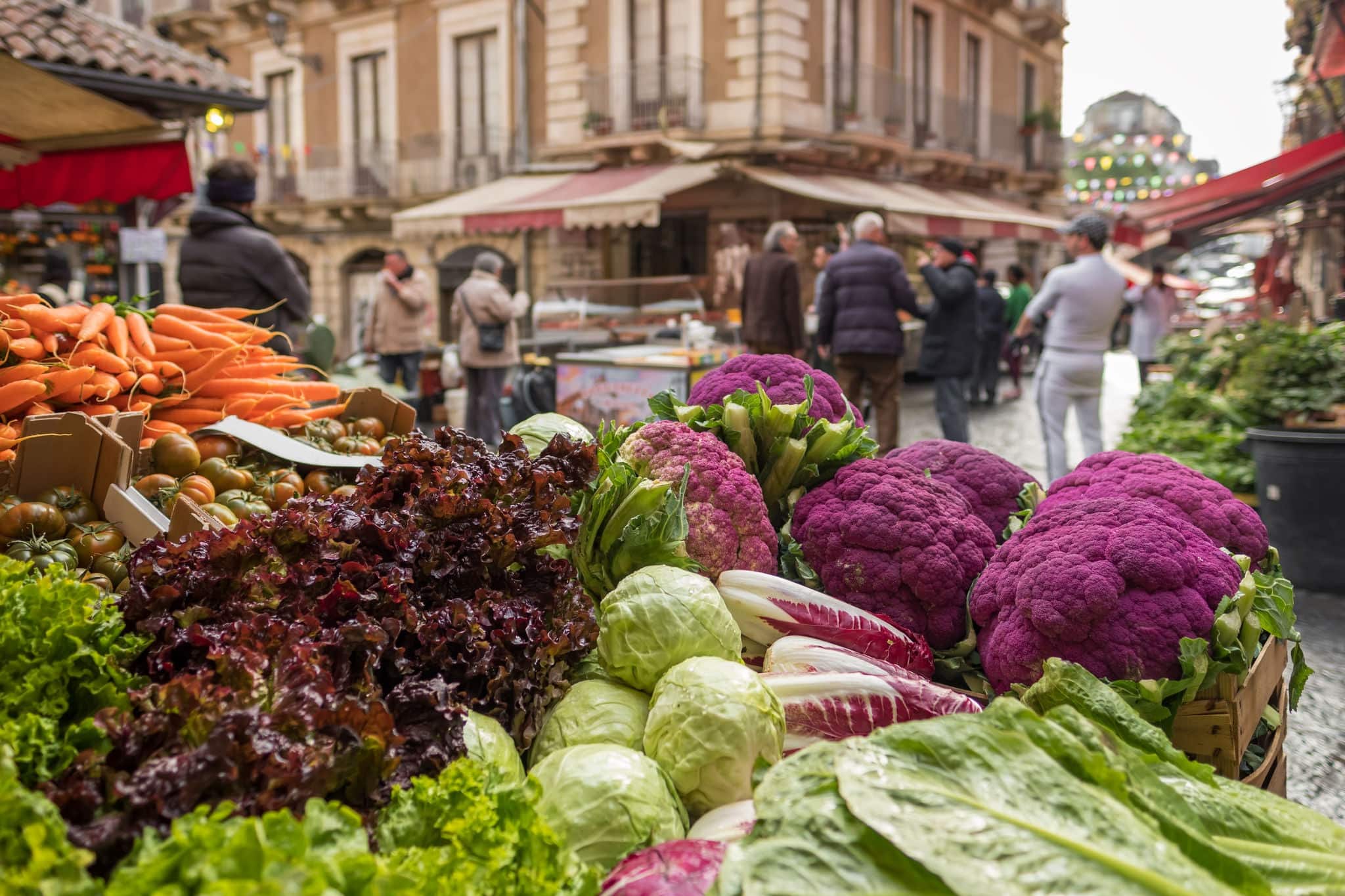Fresh vegetables: cauliflower, salad, cabbage, carrot at famous Ballaro market in Palermo, Sicily, Italy