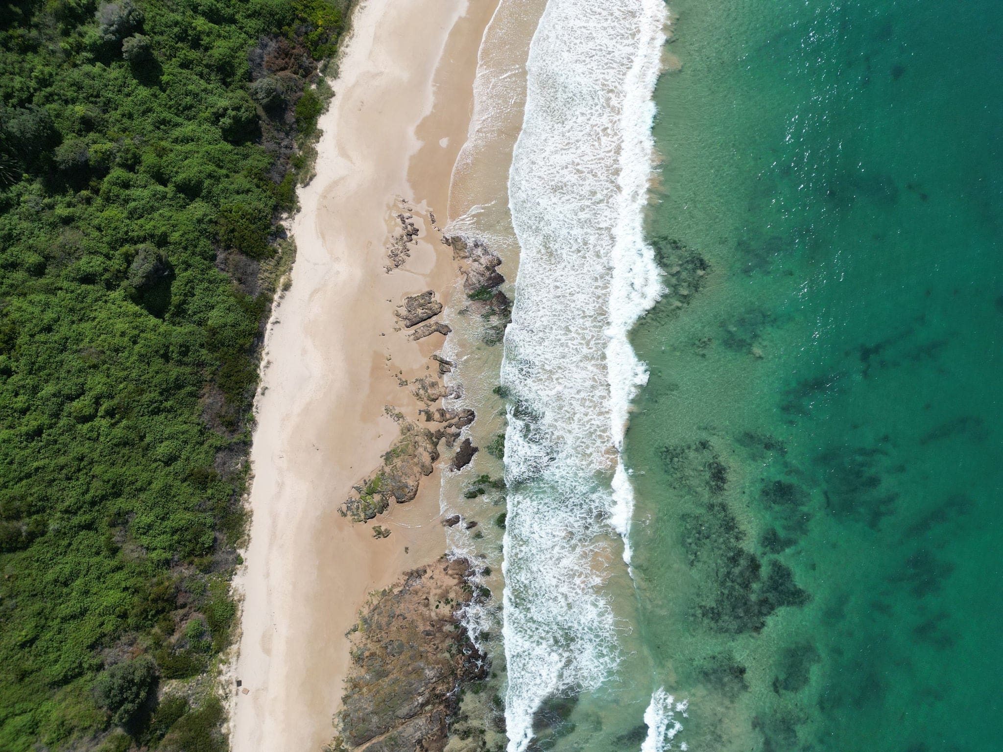 Ariel shot of  waves and landscape of MM beach from Hill 60, port Kembla, Illawarra, New South Wales, Australia