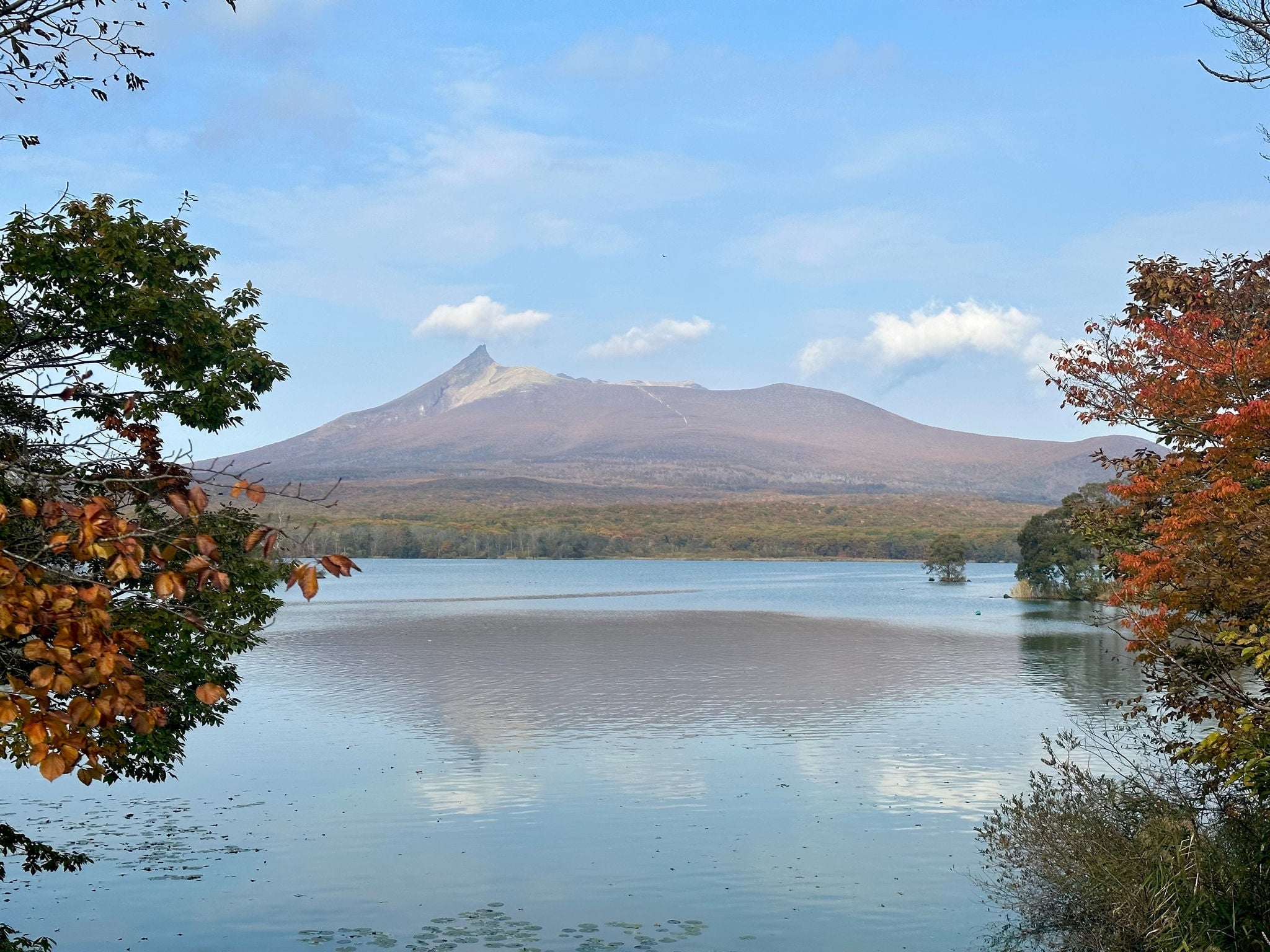 View of Mount Komagatake with its  reflection on water of Lake Onuma