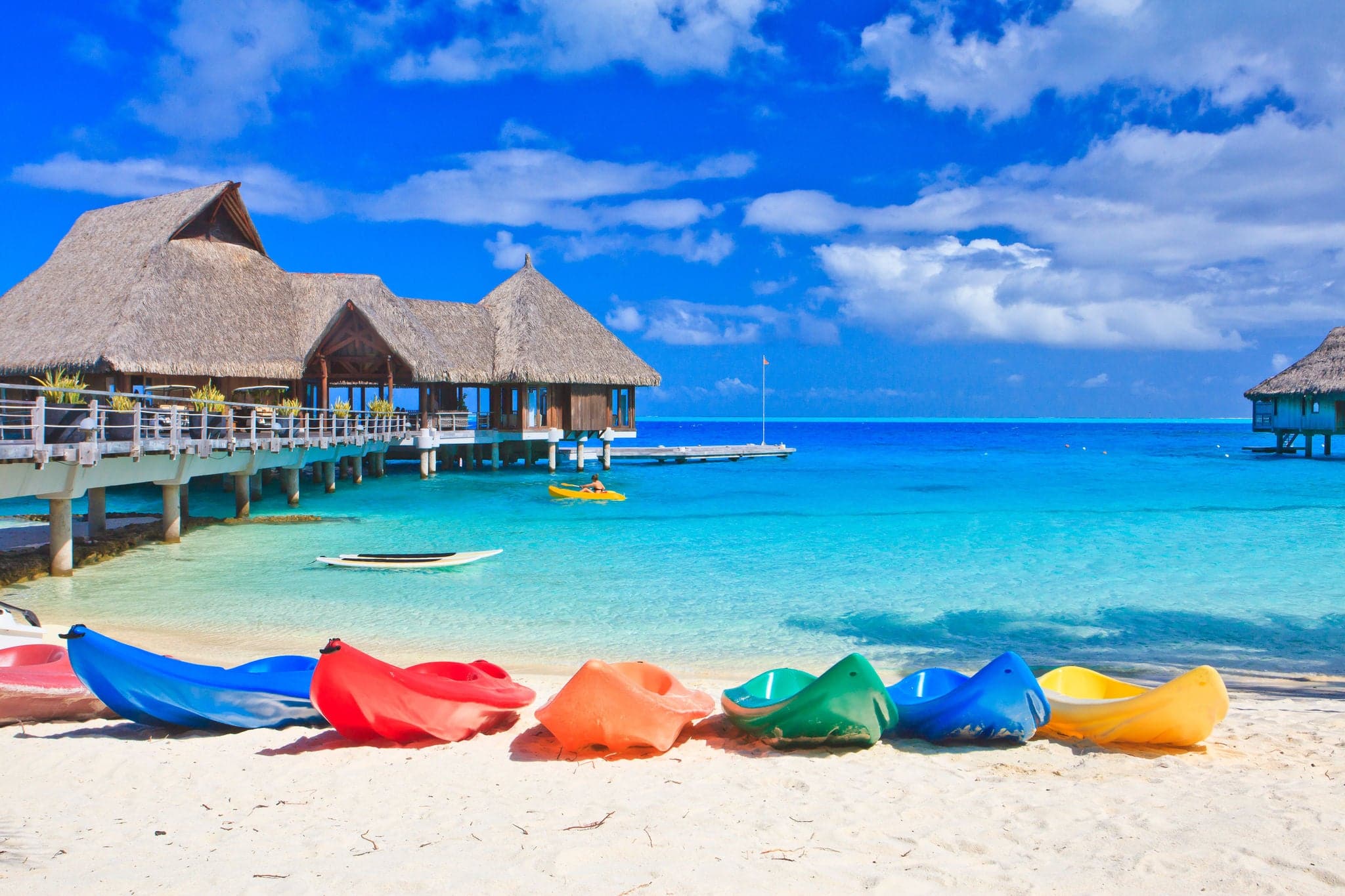 Colorful kayaks on white sand beach, Bora Bora, French Polynesia, South Pacific  Concept for relaxation, vacation, resort