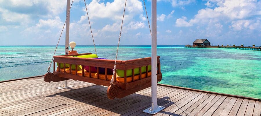 Swinging chair hammock facing beach oceanfront.