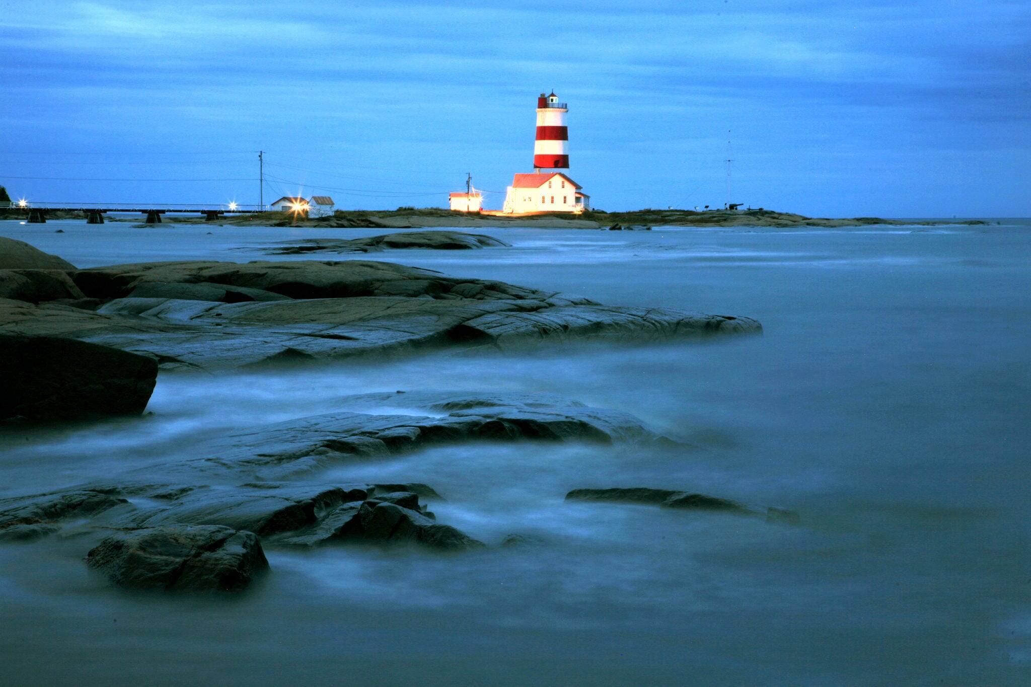 lighthouse of Pointe-des-Monts at blue hour, along St Lawrence river, Quebec, Canada