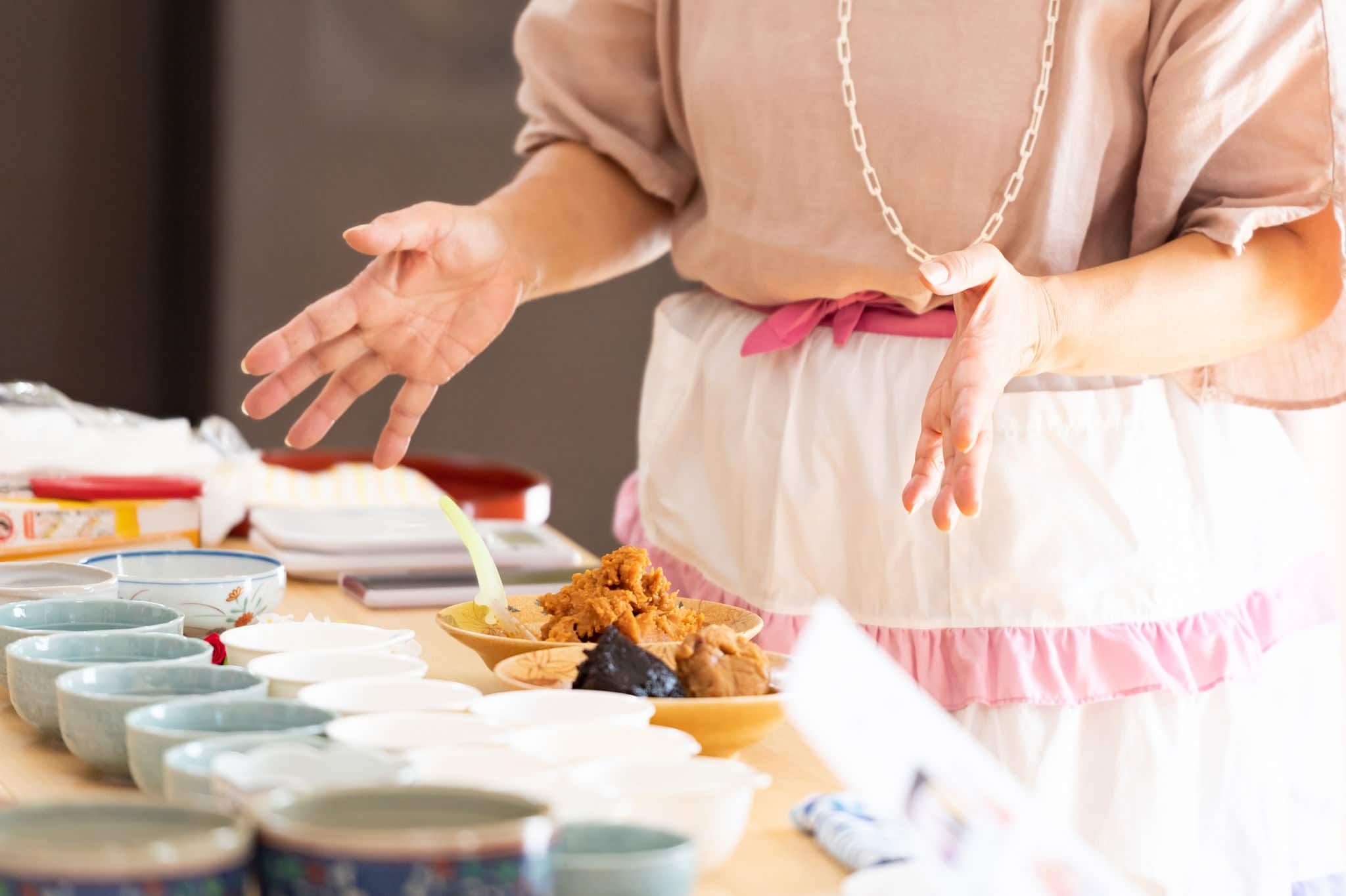 A teacher who teaches how to make Japanese miso balls in a cooking class