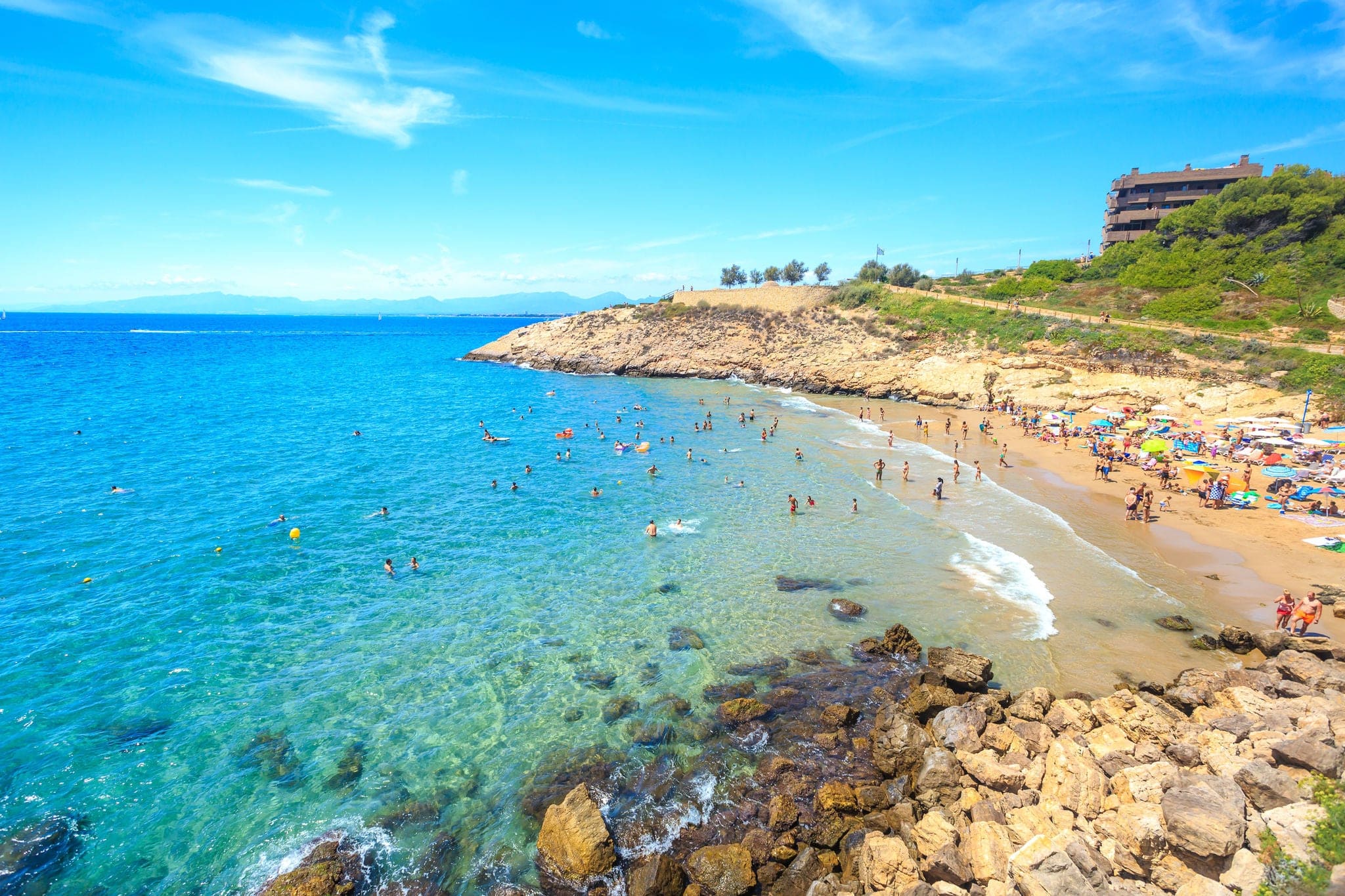 Spain, Salou. Beautiful sea lagoon with beach and tourists. Sunny day in Spain.