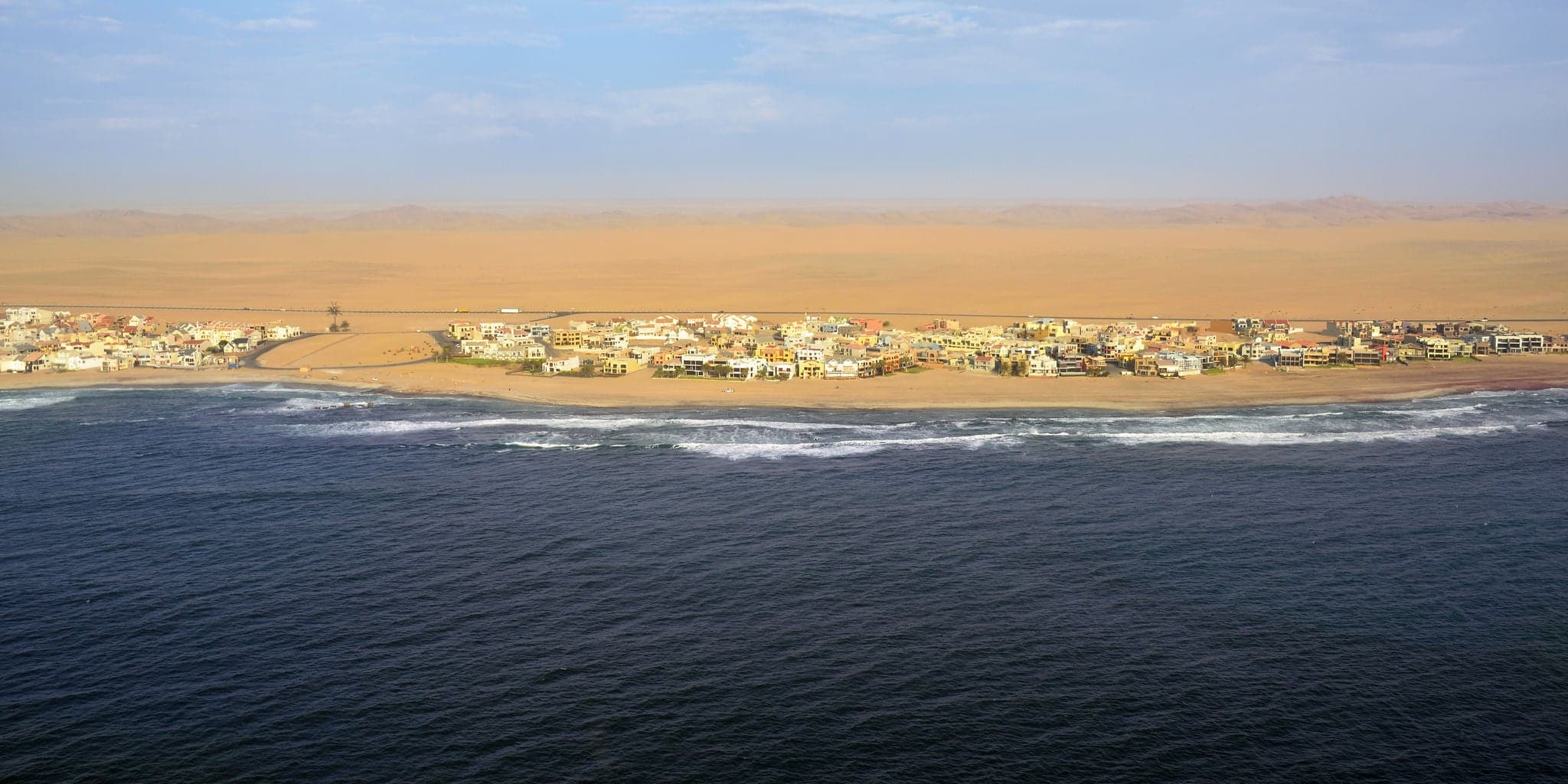 Aerial view on the coast in Namibia and modern districrt of the city Walvis Bay in the Namib desert, Atlantic ocean, Africa