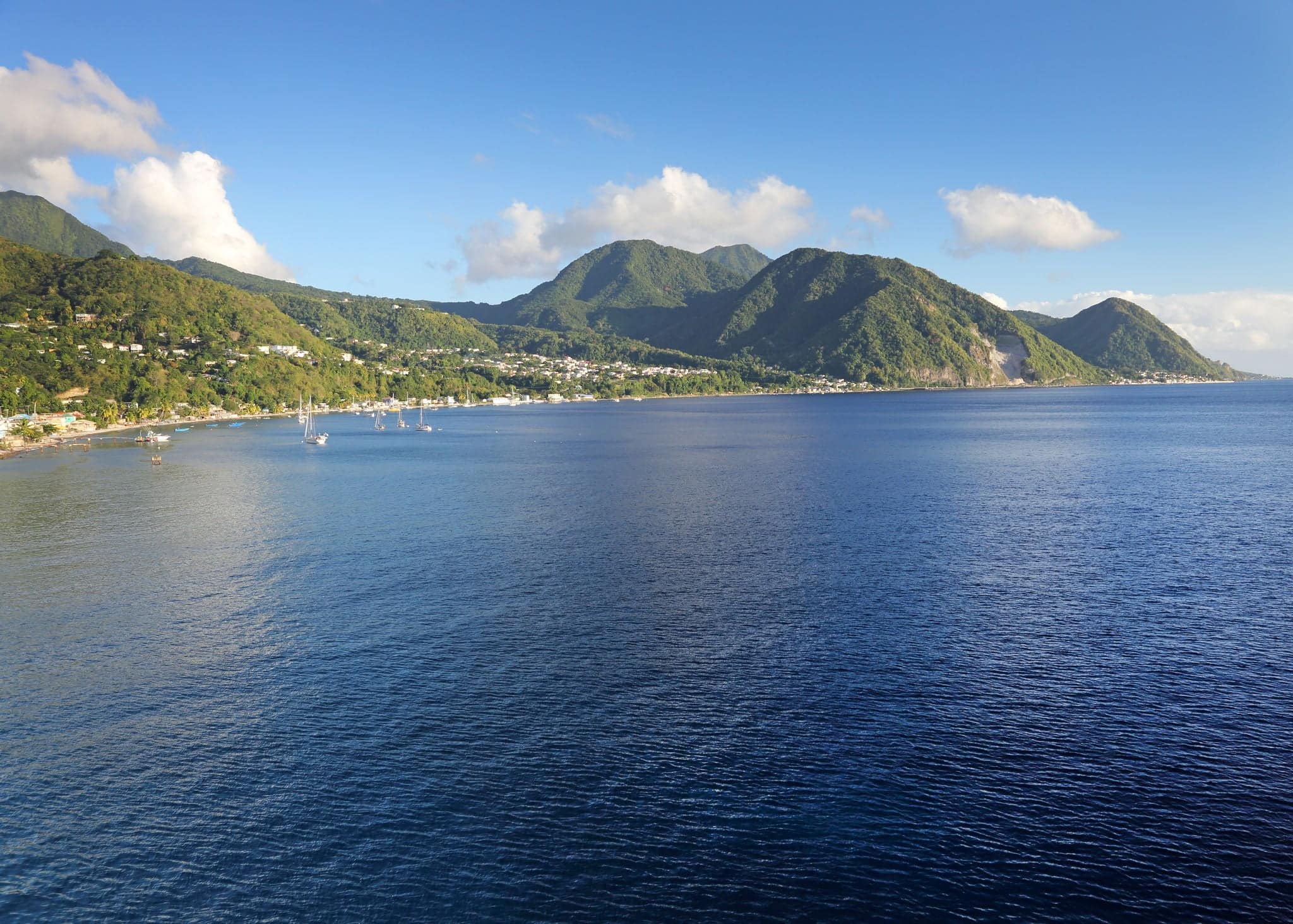 Rugged tropical hills meet the sea.