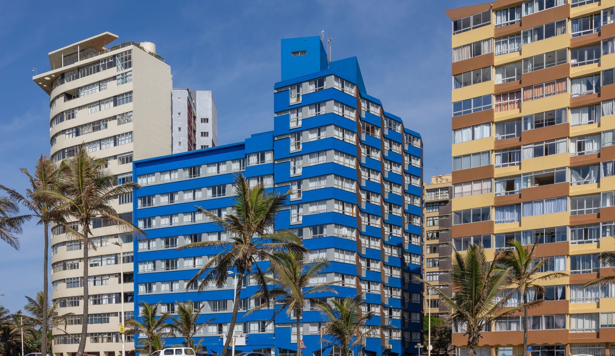 Residential and holiday apartment accommodation buildings in three high rises on the Durban palm tree lined beachfront, a popular holiday destination in KwaZulu Natal in South Africa.
