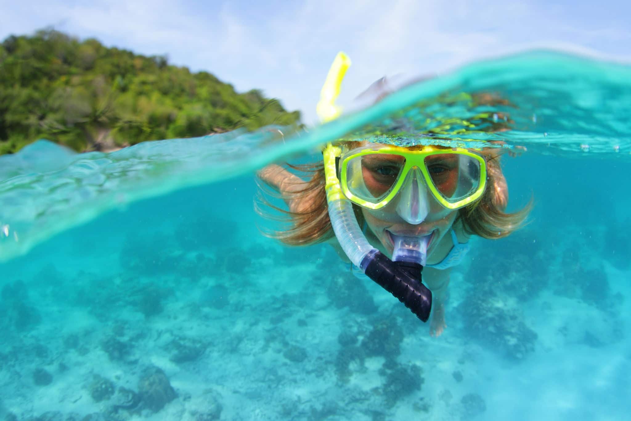 Underwater portrait of a woman snorkeling in tropical sea